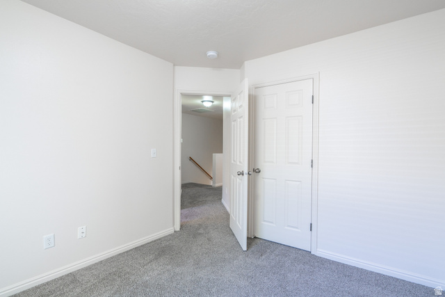 1735 West 540 North, Unit 1805 St. George, UT 84770 - Photo 58 of 64 Carpeted room with white walls, baseboards, and a six-panel interior door