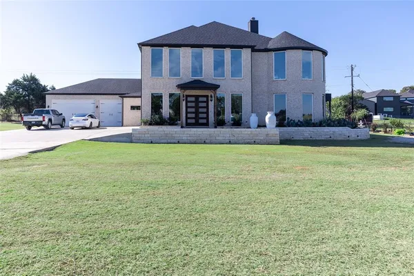 a front view of house with yard and outdoor seating