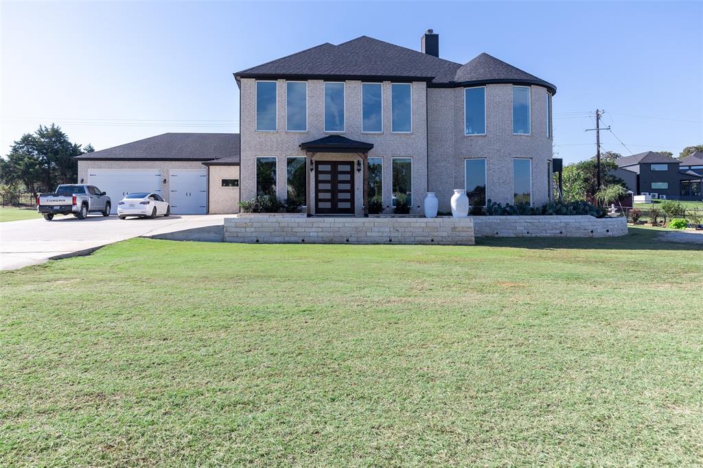 2630 Rockhill Road Aubrey, TX 76227 - Photo 1 of 36 a front view of house with yard and outdoor seating