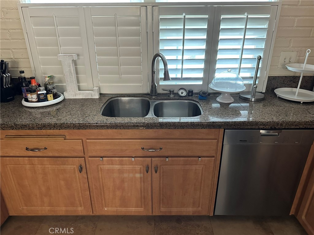 2752 Wanda Avenue Simi Valley, CA 93065 - Photo 11 of 40 a kitchen with granite countertop a sink and a window