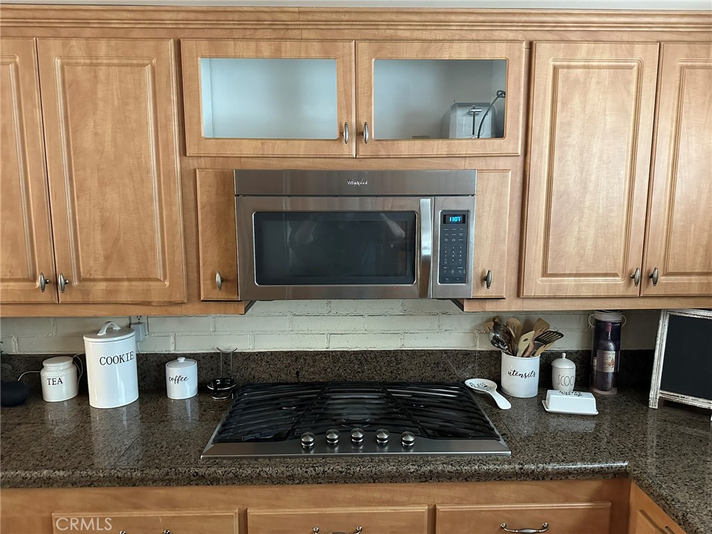 2752 Wanda Avenue Simi Valley, CA 93065 - Photo 12 of 40 a kitchen with granite countertop a stove a sink and a white cabinets