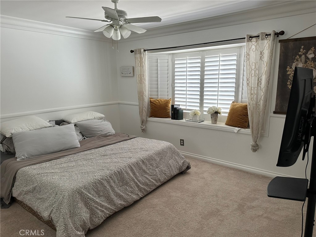 2752 Wanda Avenue Simi Valley, CA 93065 - Photo 17 of 40 a bedroom with a bed a flat screen tv and a large window