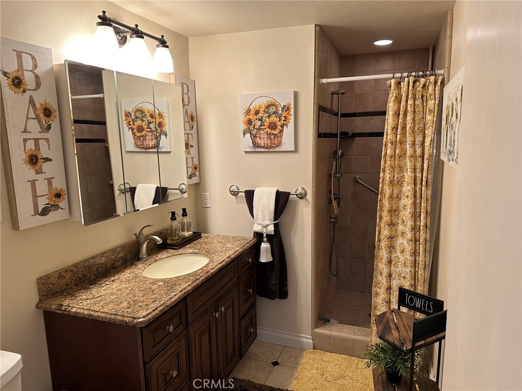 2752 Wanda Avenue Simi Valley, CA 93065 - Photo 19 of 40 a bathroom with a granite countertop sink and a mirror