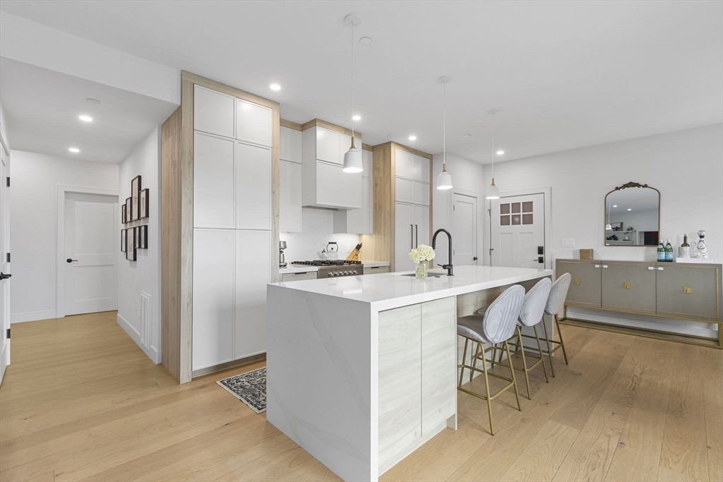 4 Payne Street, Unit ONE Boston, MA 02122 - Photo 1 of 18 a kitchen with kitchen island a sink stove and refrigerator