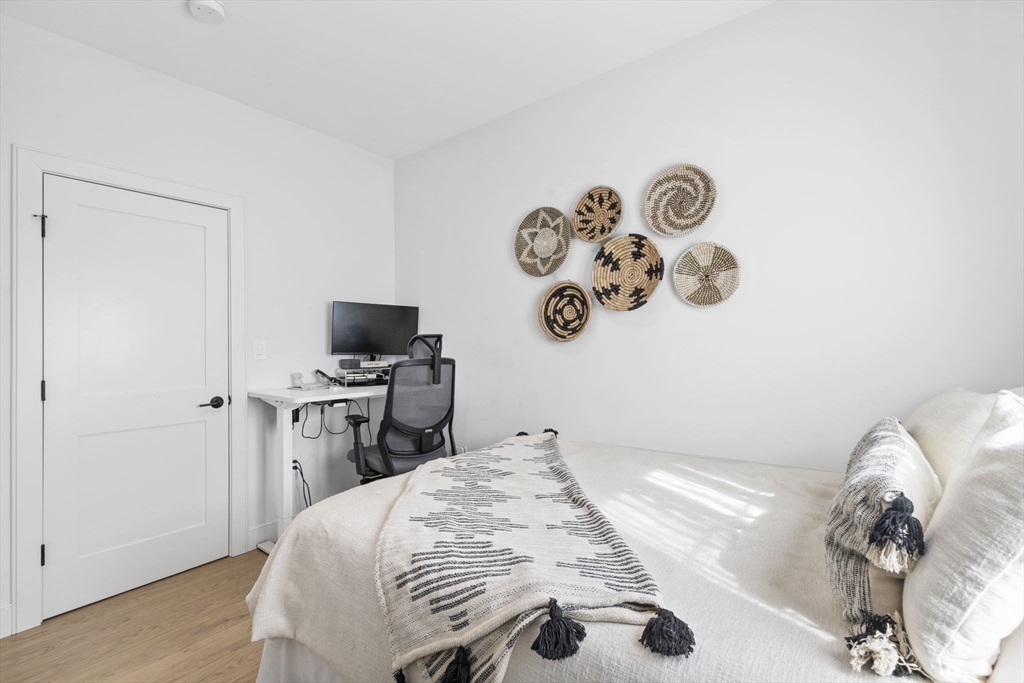 4 Payne Street, Unit ONE Boston, MA 02122 - Photo 12 of 18 a bedroom with a bed and a television
