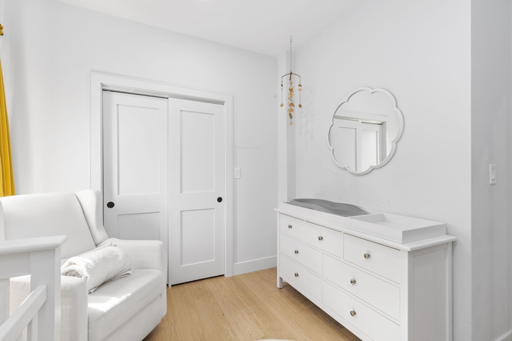 4 Payne Street, Unit ONE Boston, MA 02122 - Photo 14 of 18 a room with a furniture and a mirror