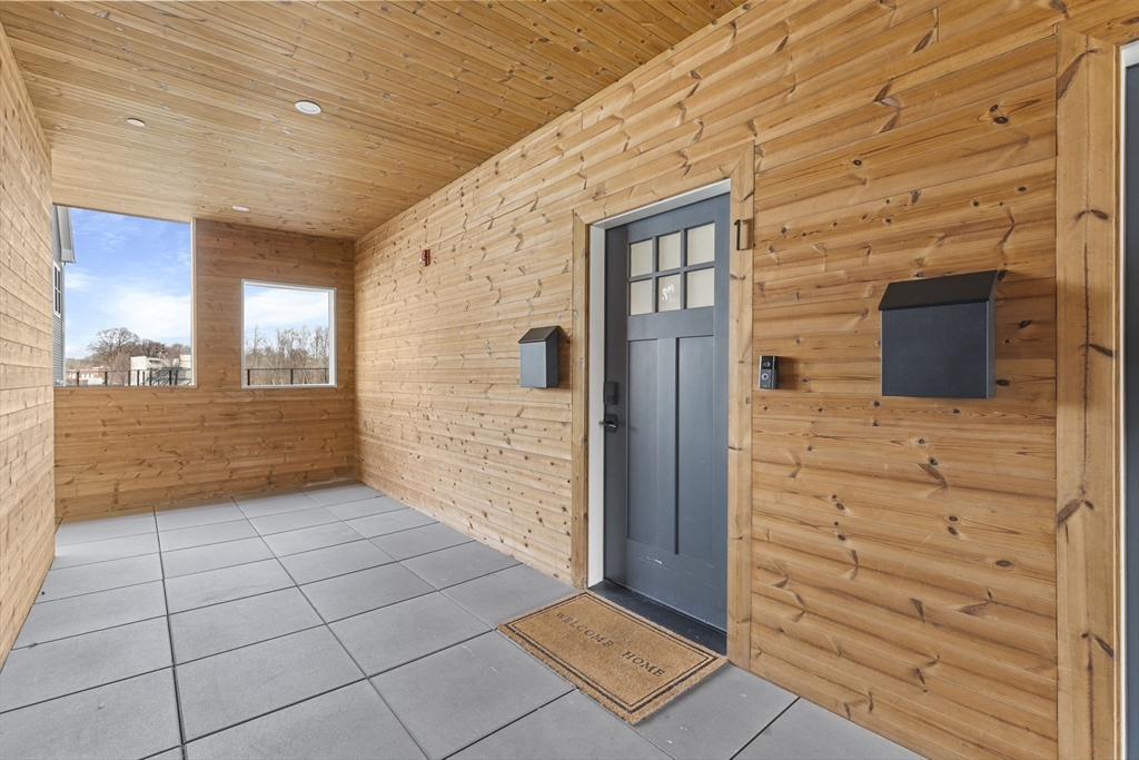 4 Payne Street, Unit ONE Boston, MA 02122 - Photo 18 of 18 a view of a hallway with wooden floor and a bathroom
