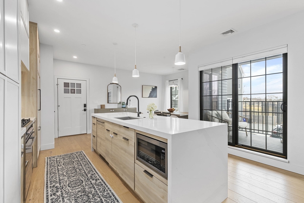 4 Payne Street, Unit ONE Boston, MA 02122 - Photo 2 of 18 a large white kitchen with a large window