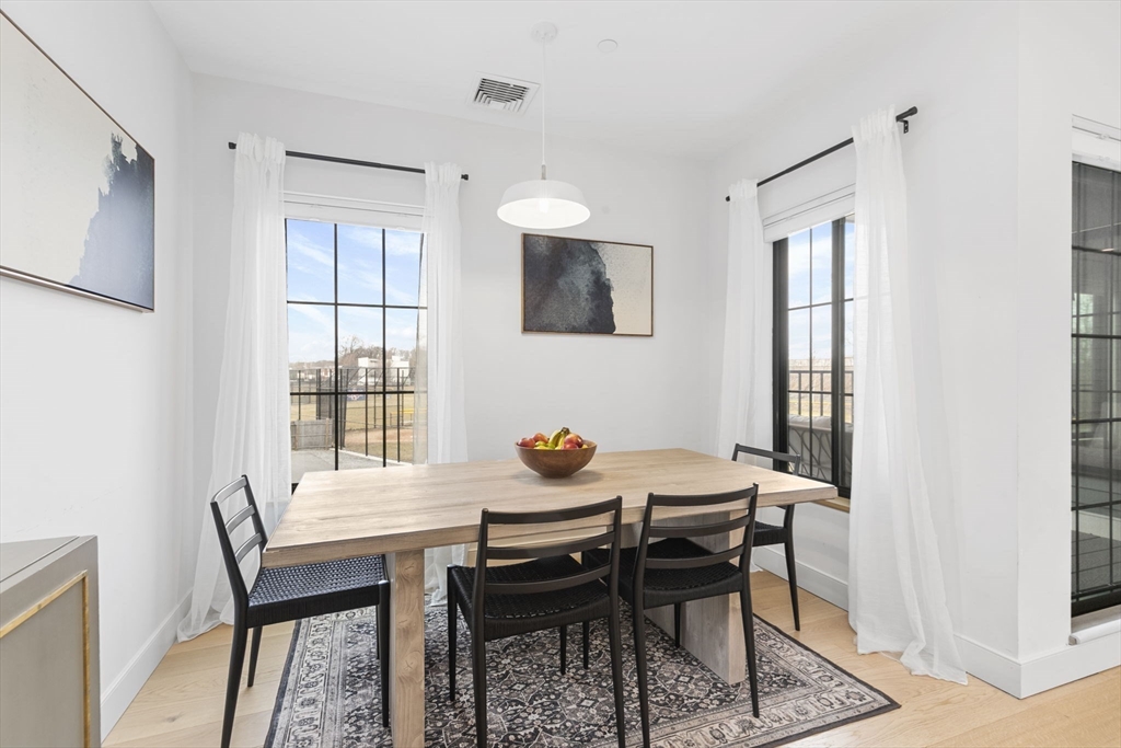 4 Payne Street, Unit ONE Boston, MA 02122 - Photo 4 of 18 a dining room with furniture and window