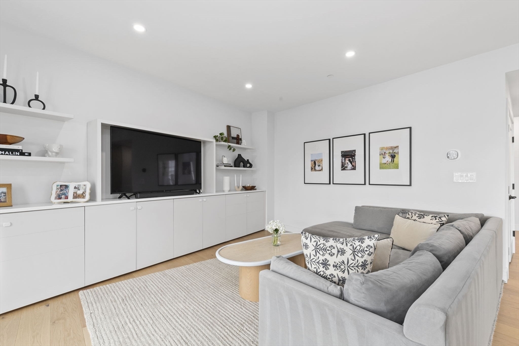 4 Payne Street, Unit ONE Boston, MA 02122 - Photo 6 of 18 a living room with furniture and a flat screen tv