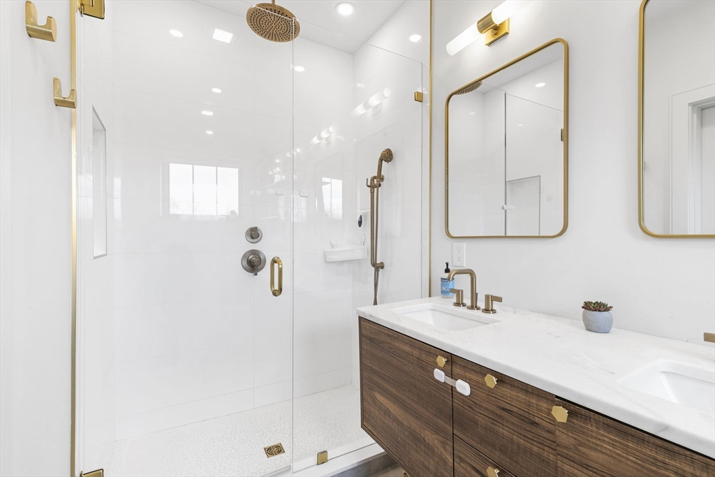 4 Payne Street, Unit ONE Boston, MA 02122 - Photo 10 of 18 a bathroom with a double vanity sink a mirror and shower