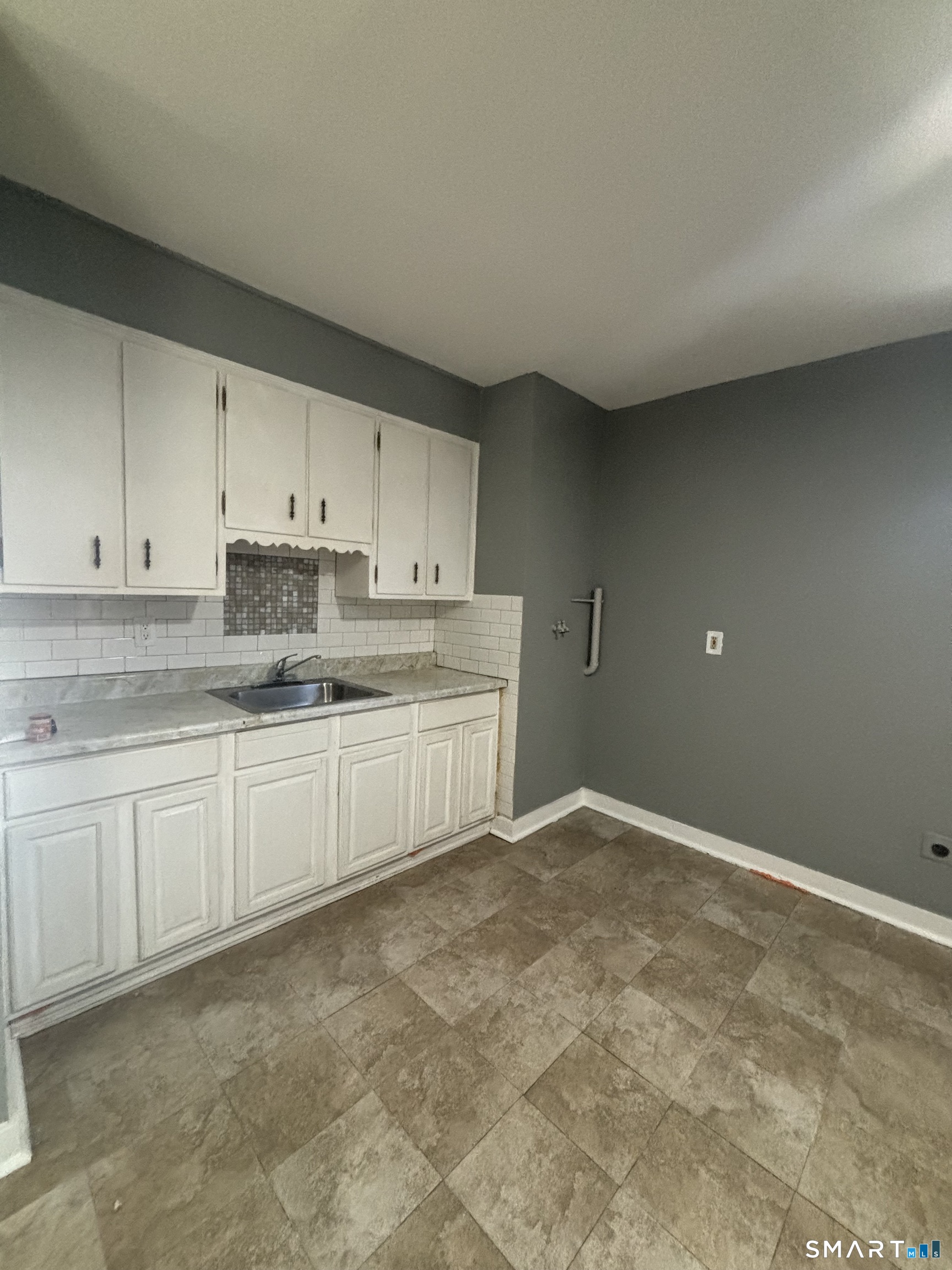 295 Shelton Street Bridgeport, CT 06608 - Photo 3 of 5 a kitchen with granite countertop white cabinets and white stainless steel appliances