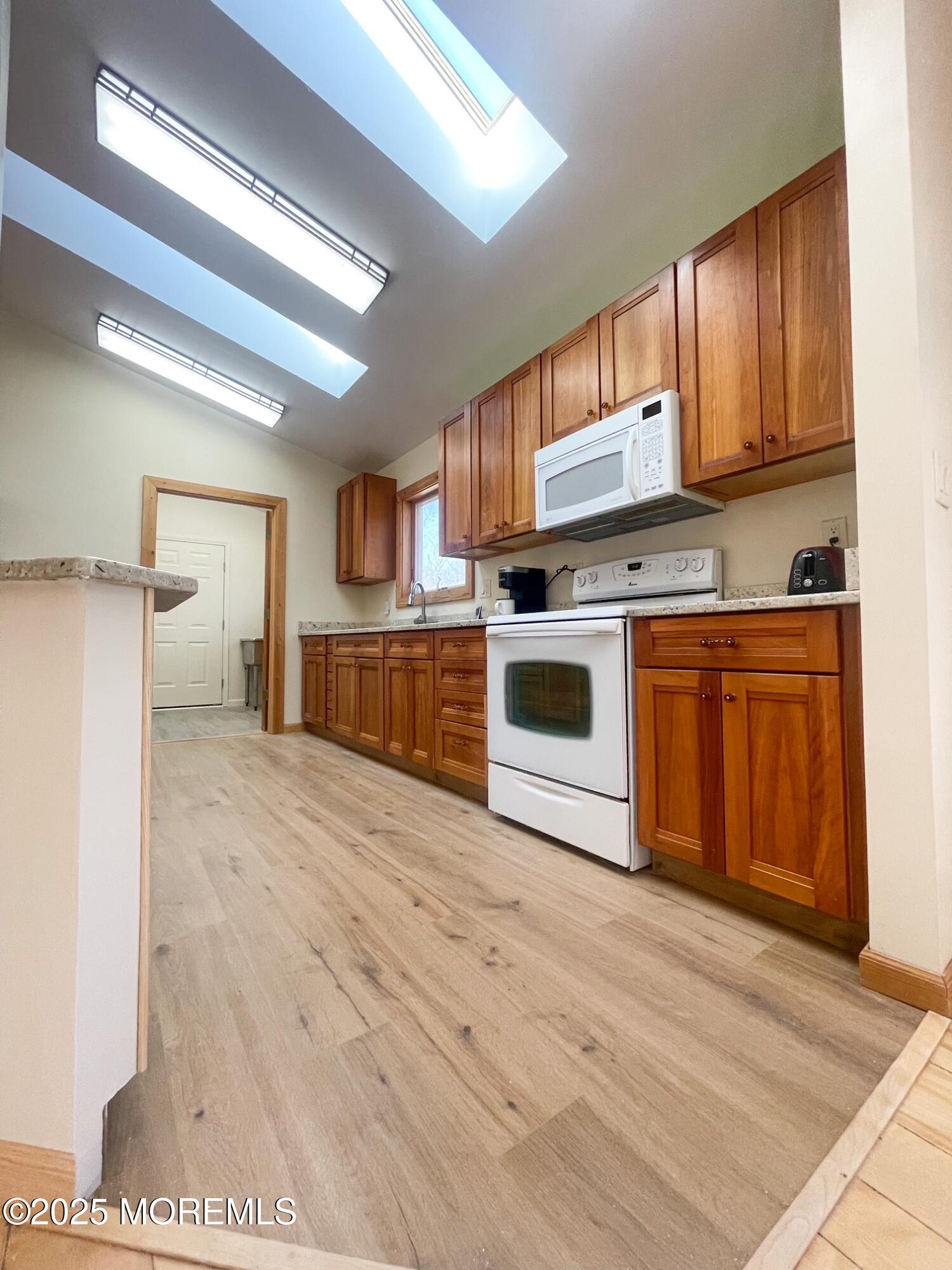 10 Spring Road Clarksburg, NJ 08510 - Photo 10 of 27 a kitchen with stainless steel appliances granite countertop a stove cabinets and wooden floor