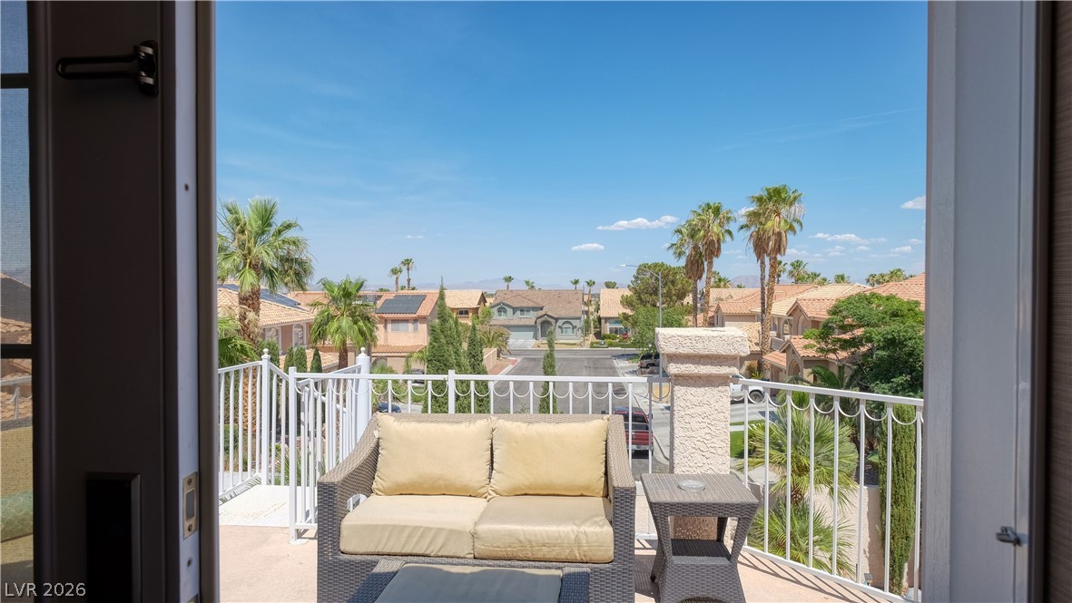 3704 North Campbell Road Las Vegas, NV 89129 - Photo 35 of 38 Step onto the balcony and enjoy expansive neighborhood views under the clear blue sky.