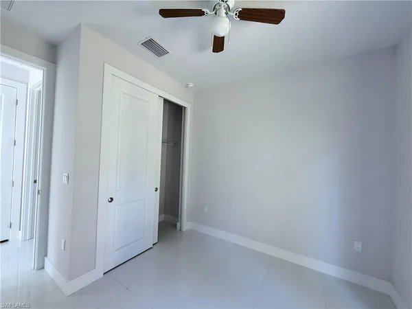 an empty room with a ceiling fan