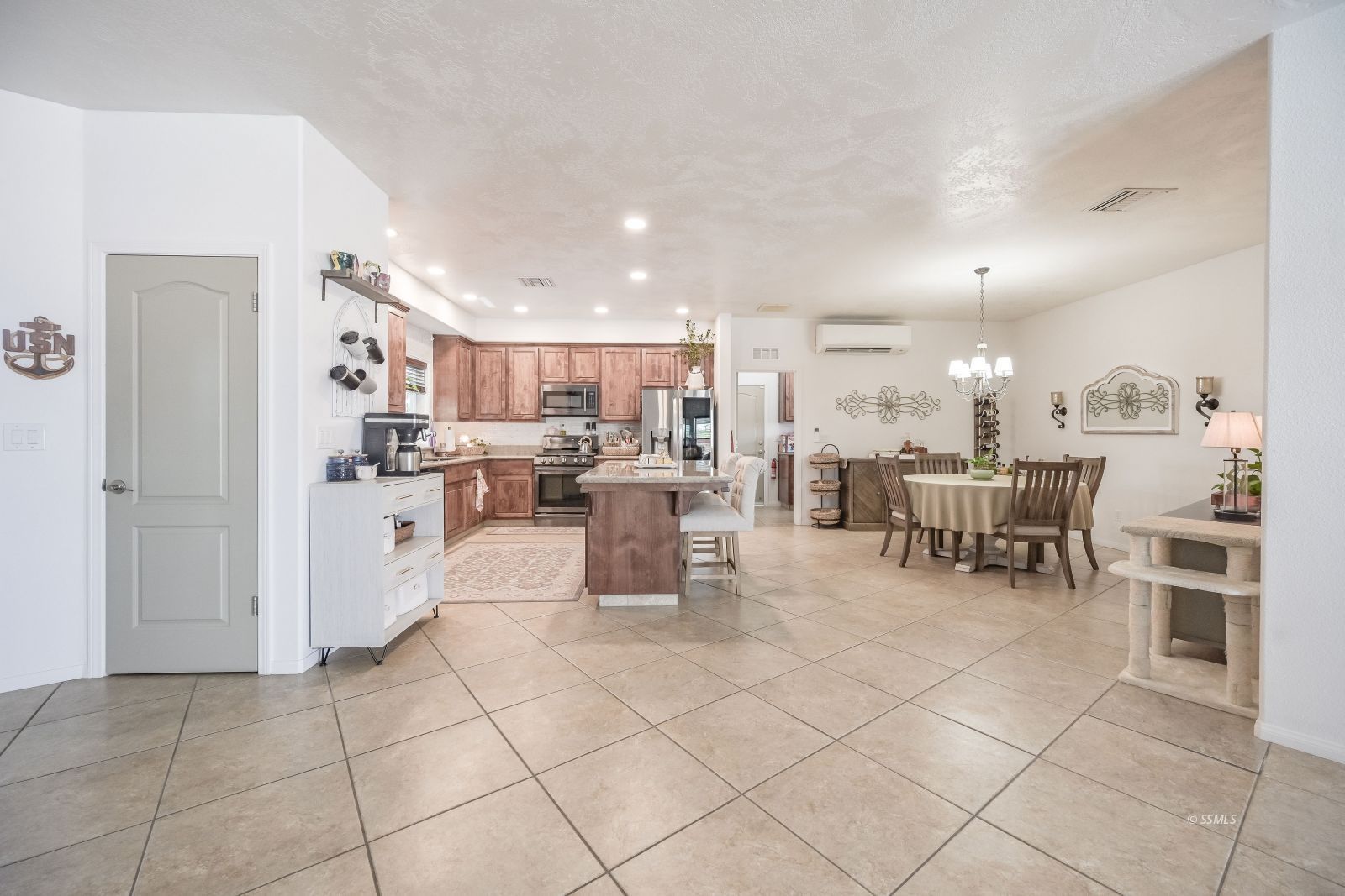 400 Acacia Street Ridgecrest, CA 93555 - Photo 5 of 45 a kitchen with stainless steel appliances lots of white furniture a refrigerator and a dining table