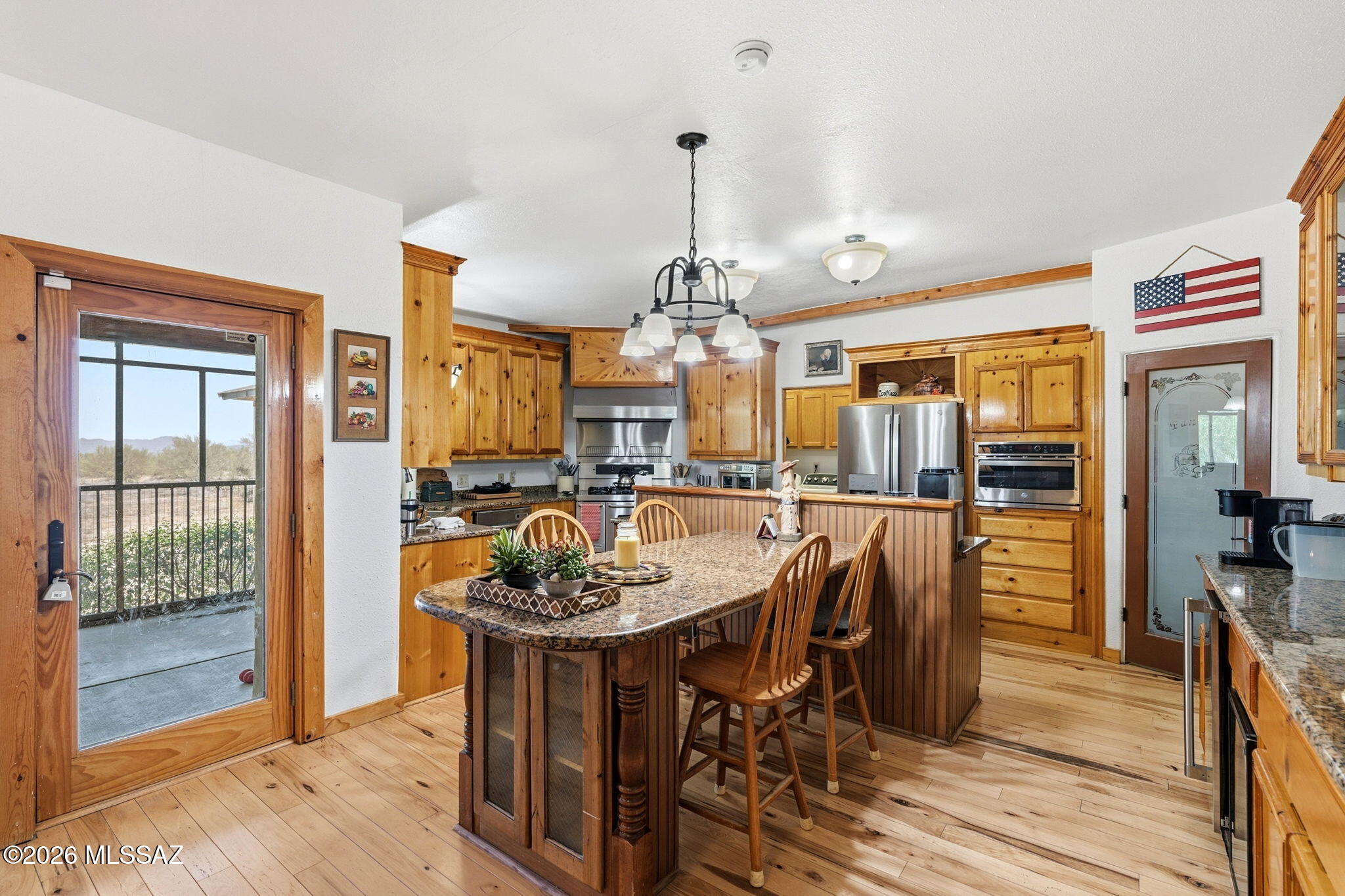 12810 West Gunsmoke Road Tucson, AZ 85736 - Photo 12 of 51 a dining room filled chandelier and wooden floor
