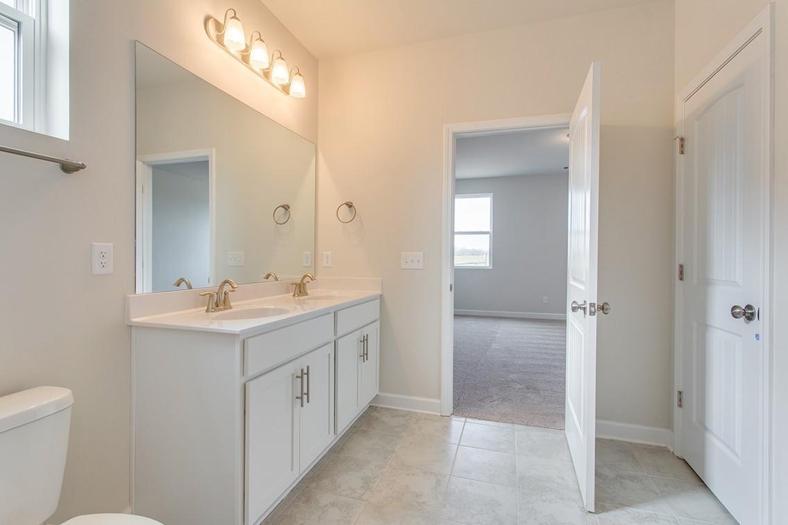1310 Kristopher Drive Lebanon, TN 37087 - Photo 34 of 34 a bathroom with a double vanity sink and mirror with toilet