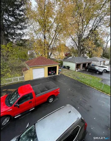 a backyard of a house with cars parked