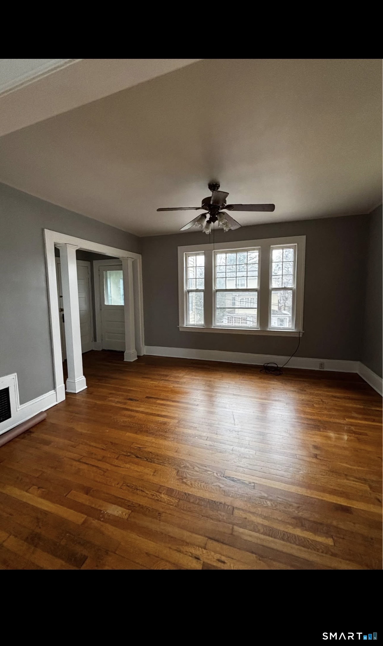 448 Hillside Avenue, Unit 2 Hartford, CT 06106 - Photo 3 of 11 a view of an empty room with window and wooden floor