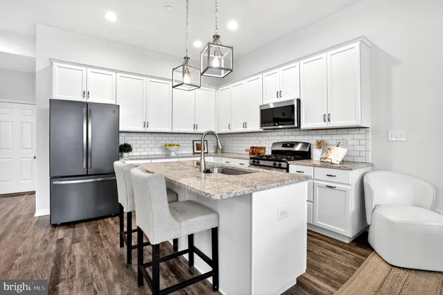 a living room with furniture a flat screen tv and a large window
