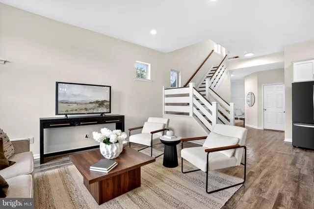 a kitchen with stainless steel appliances kitchen island granite countertop a table chairs sink and cabinets