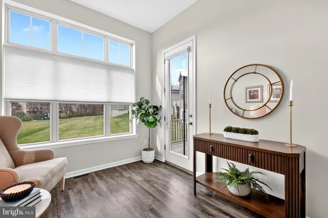 a kitchen with stainless steel appliances granite countertop a refrigerator a sink dishwasher a stove and white cabinets with wooden floor