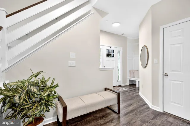 a living room with furniture a rug and a flat screen tv