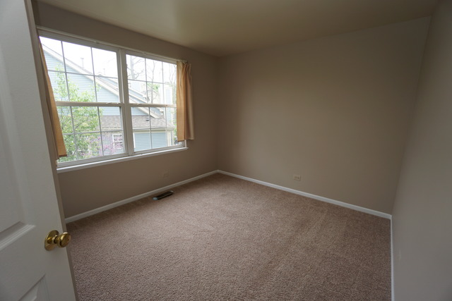 1129 Coldspring Road Elgin, IL 60120 - Photo 11 of 18 an empty room with a window