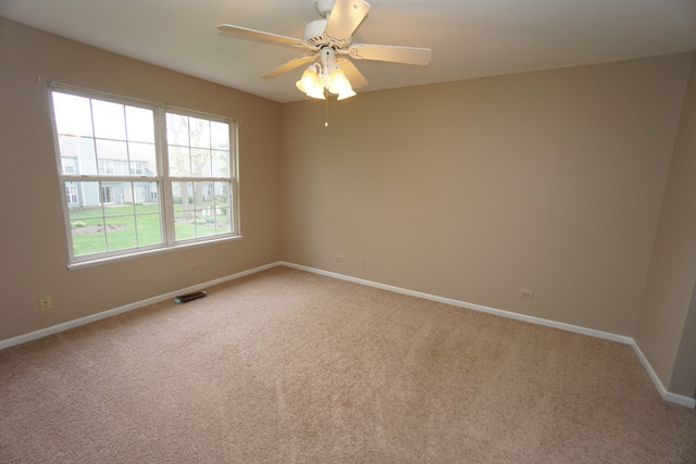1129 Coldspring Road Elgin, IL 60120 - Photo 12 of 18 an empty room with a window and a fan