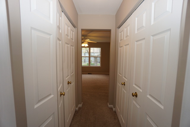 1129 Coldspring Road Elgin, IL 60120 - Photo 14 of 18 a view of a hallway with wooden floor and a door