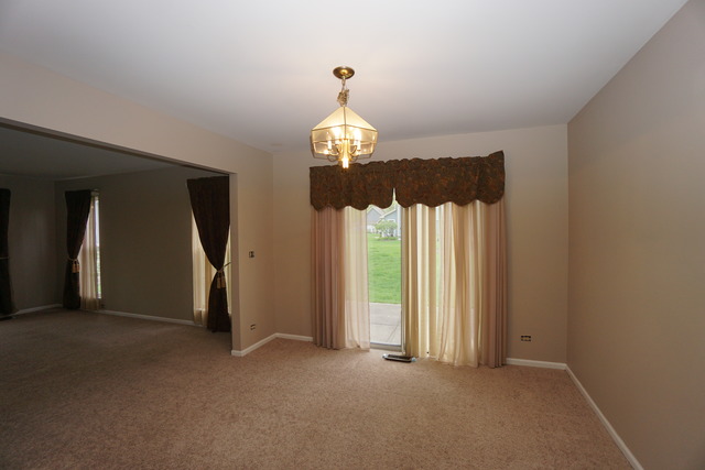 1129 Coldspring Road Elgin, IL 60120 - Photo 6 of 18 a view of entryway with chandelier