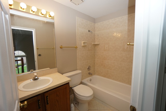 1129 Coldspring Road Elgin, IL 60120 - Photo 10 of 18 a bathroom with a sink toilet and shower