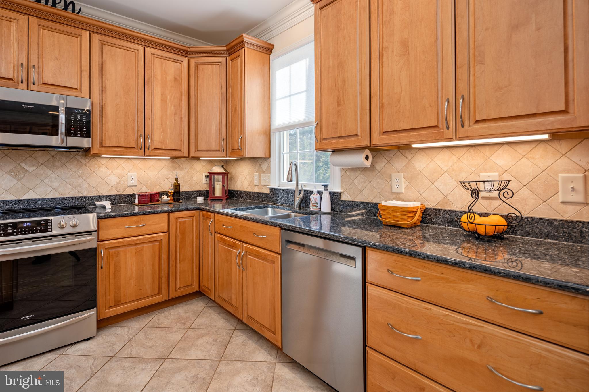 115 Cedar Road Chester, MD 21619 - Photo 11 of 71 a kitchen with stainless steel appliances granite countertop a sink a stove a microwave and cabinets