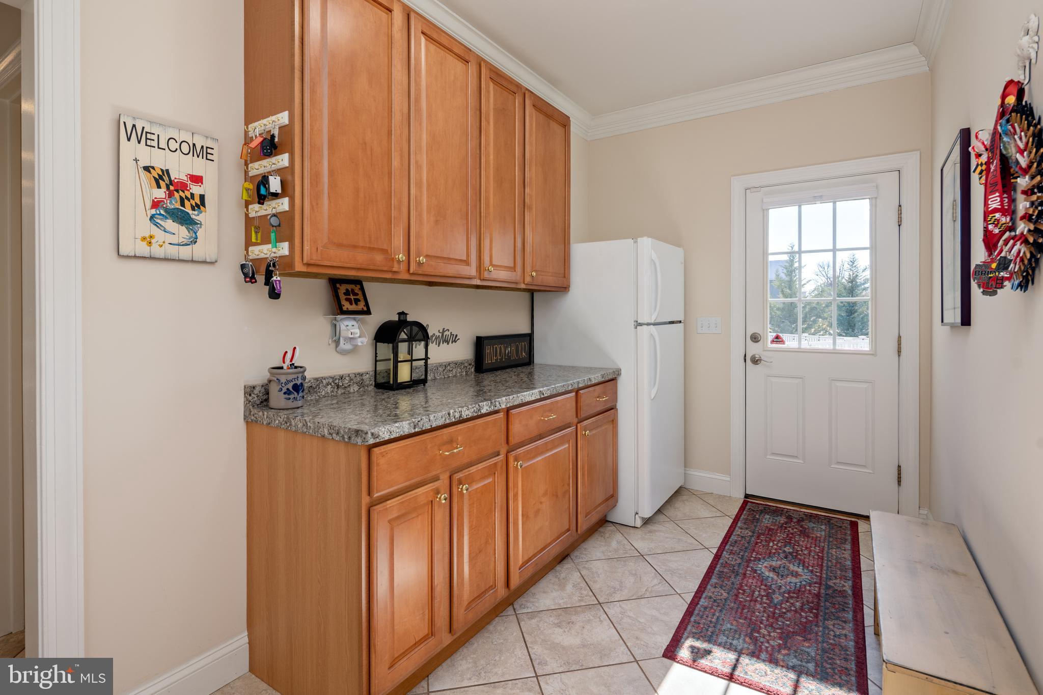 115 Cedar Road Chester, MD 21619 - Photo 27 of 71 a kitchen with stainless steel appliances granite countertop a refrigerator and a stove top oven
