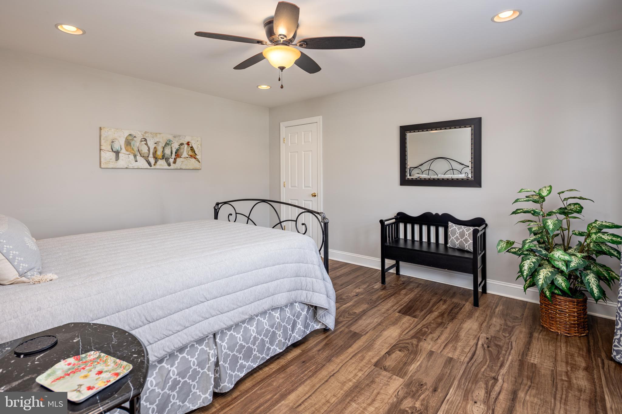 115 Cedar Road Chester, MD 21619 - Photo 44 of 71 a bedroom with a bed and a chandelier