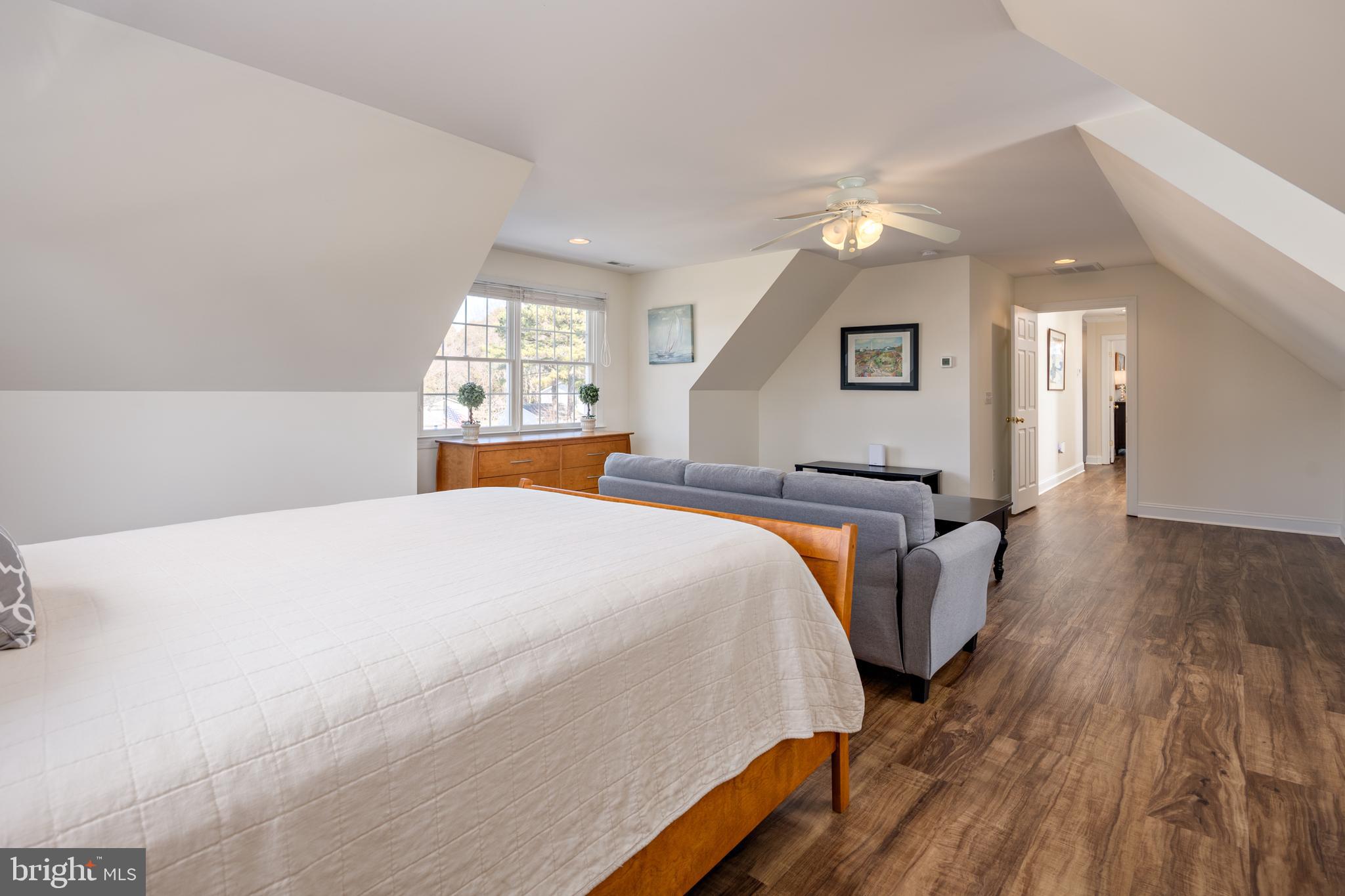 115 Cedar Road Chester, MD 21619 - Photo 49 of 71 a spacious bedroom with a bed and a chandelier