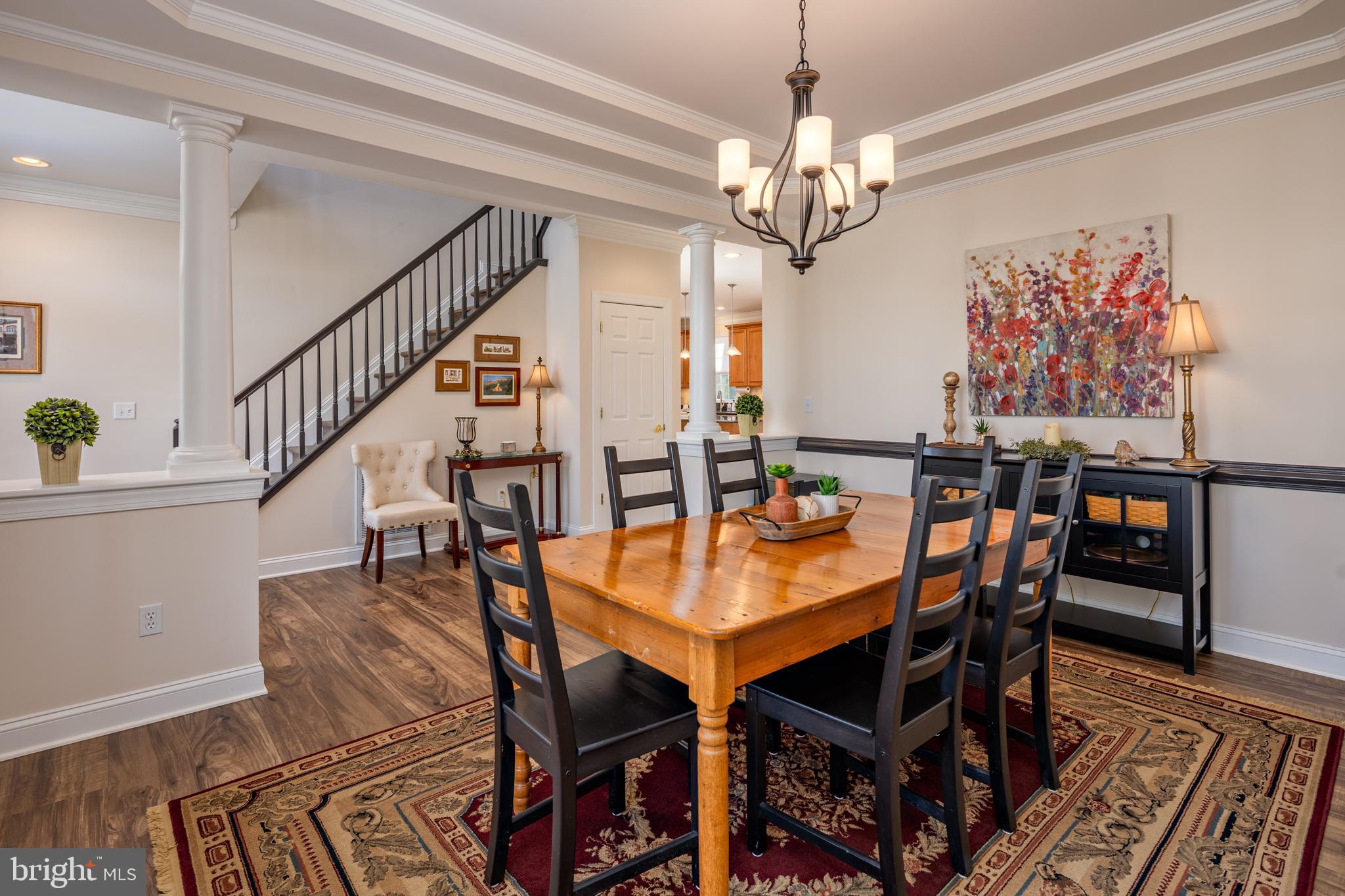 115 Cedar Road Chester, MD 21619 - Photo 8 of 71 a dining room with furniture a chandelier and wooden floor