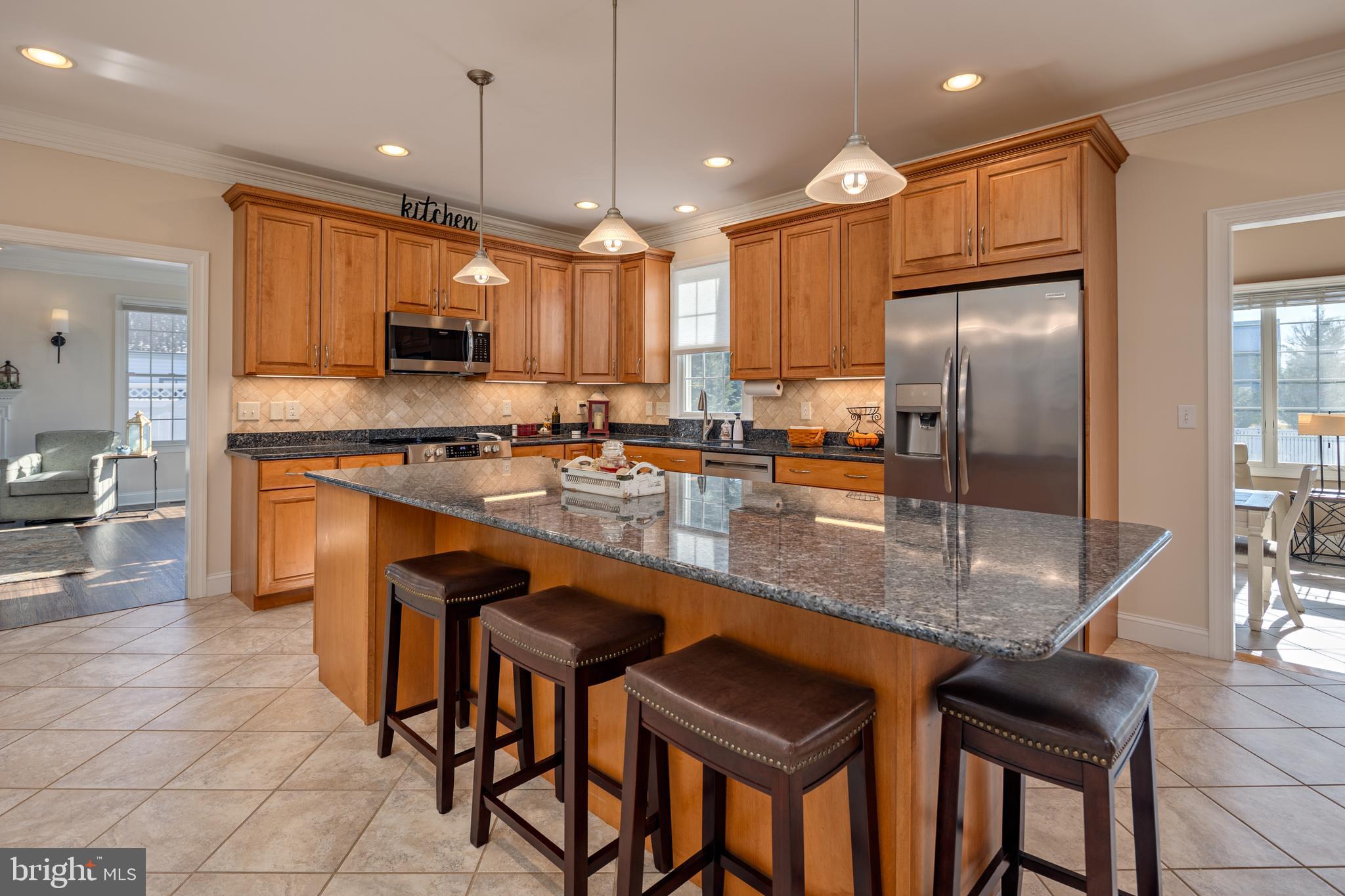 115 Cedar Road Chester, MD 21619 - Photo 10 of 71 a kitchen with stainless steel appliances granite countertop table chairs sink and cabinets