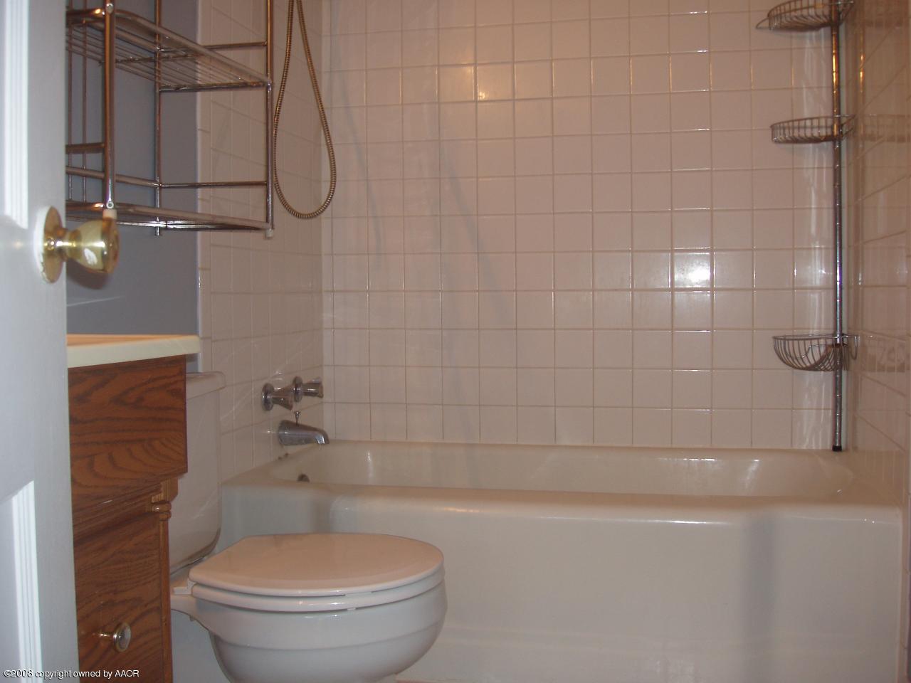 4303 South Jackson Street Amarillo, TX 79110 - Photo 11 of 18 a bathroom with a toilet and a shower