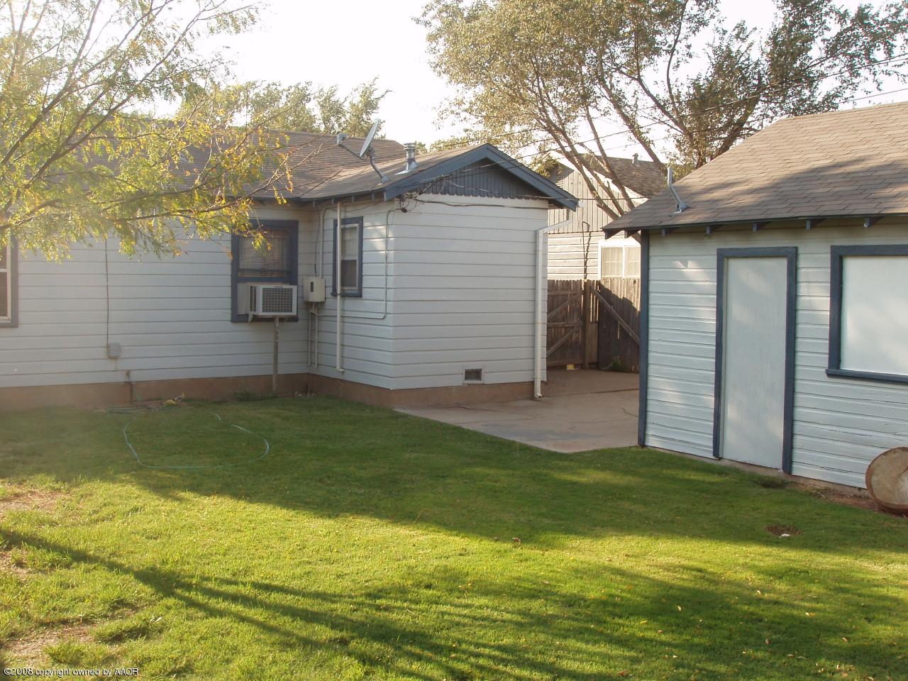 4303 South Jackson Street Amarillo, TX 79110 - Photo 17 of 18 a view of a backyard with a large tree