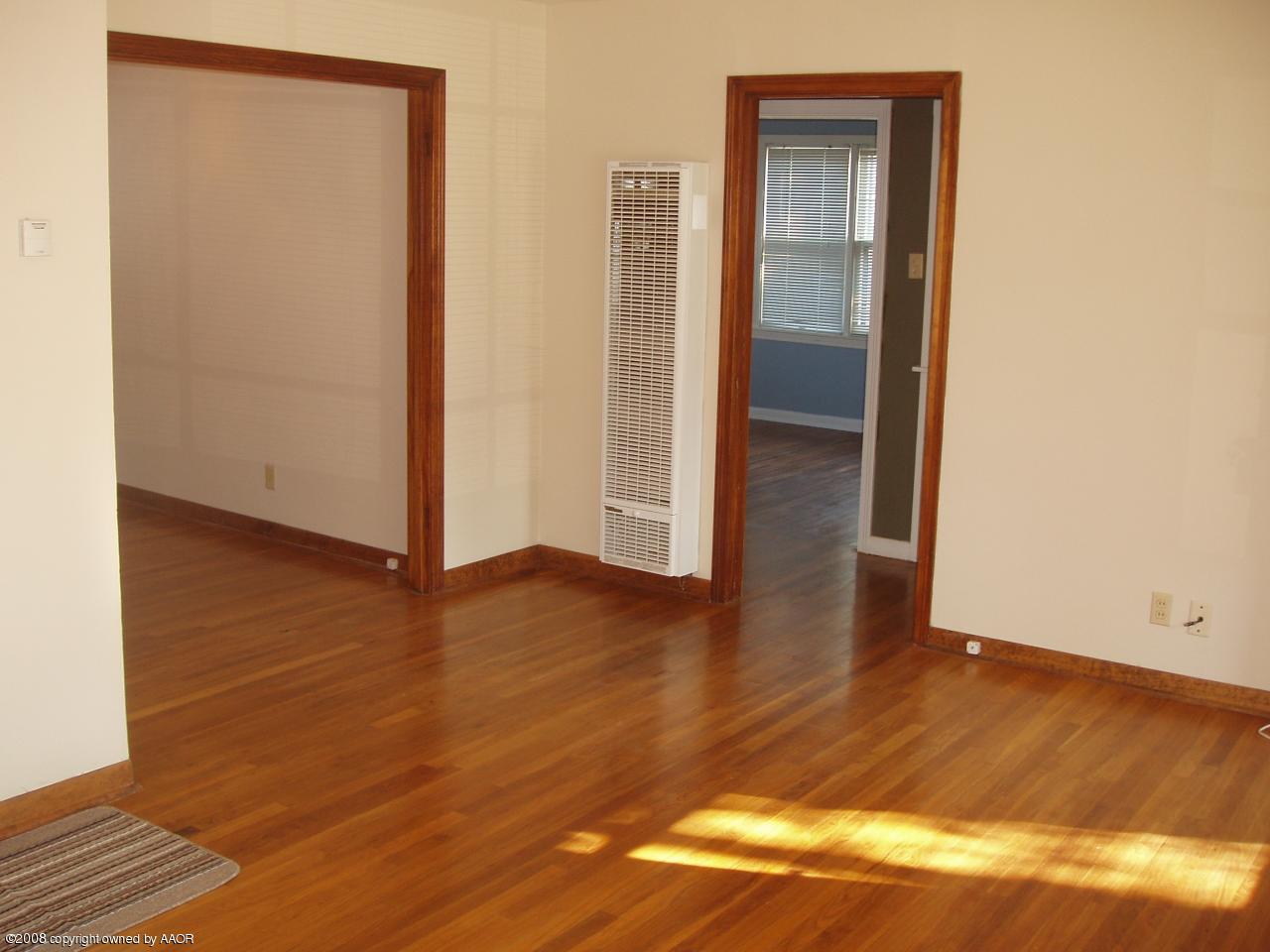4303 South Jackson Street Amarillo, TX 79110 - Photo 5 of 18 an empty room with wooden floor and closet