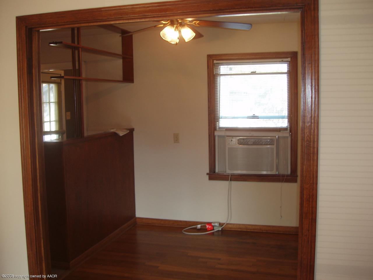 4303 South Jackson Street Amarillo, TX 79110 - Photo 6 of 18 a room that has a window in it and wooden floor