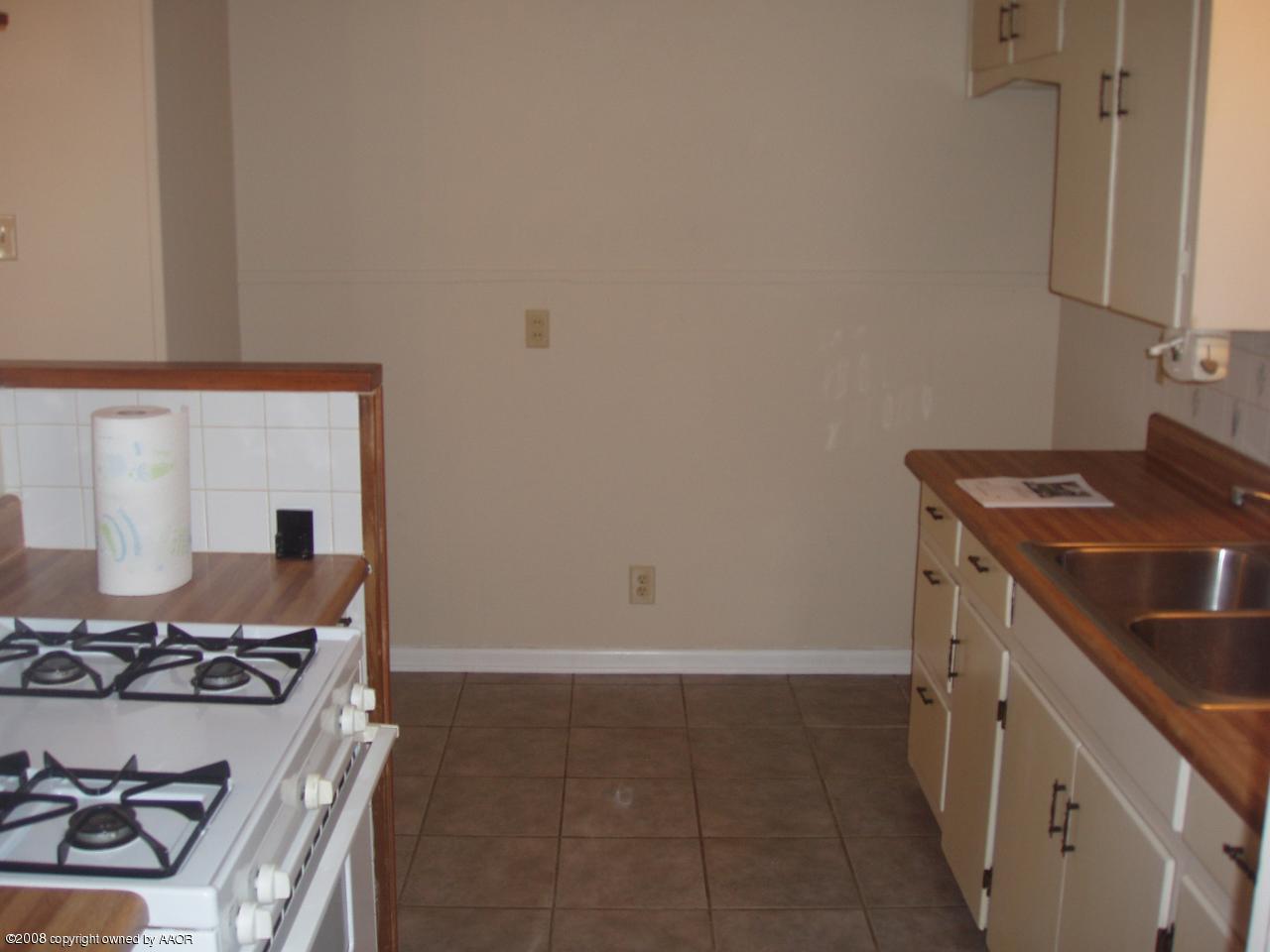 4303 South Jackson Street Amarillo, TX 79110 - Photo 8 of 18 a kitchen with a stove and a sink