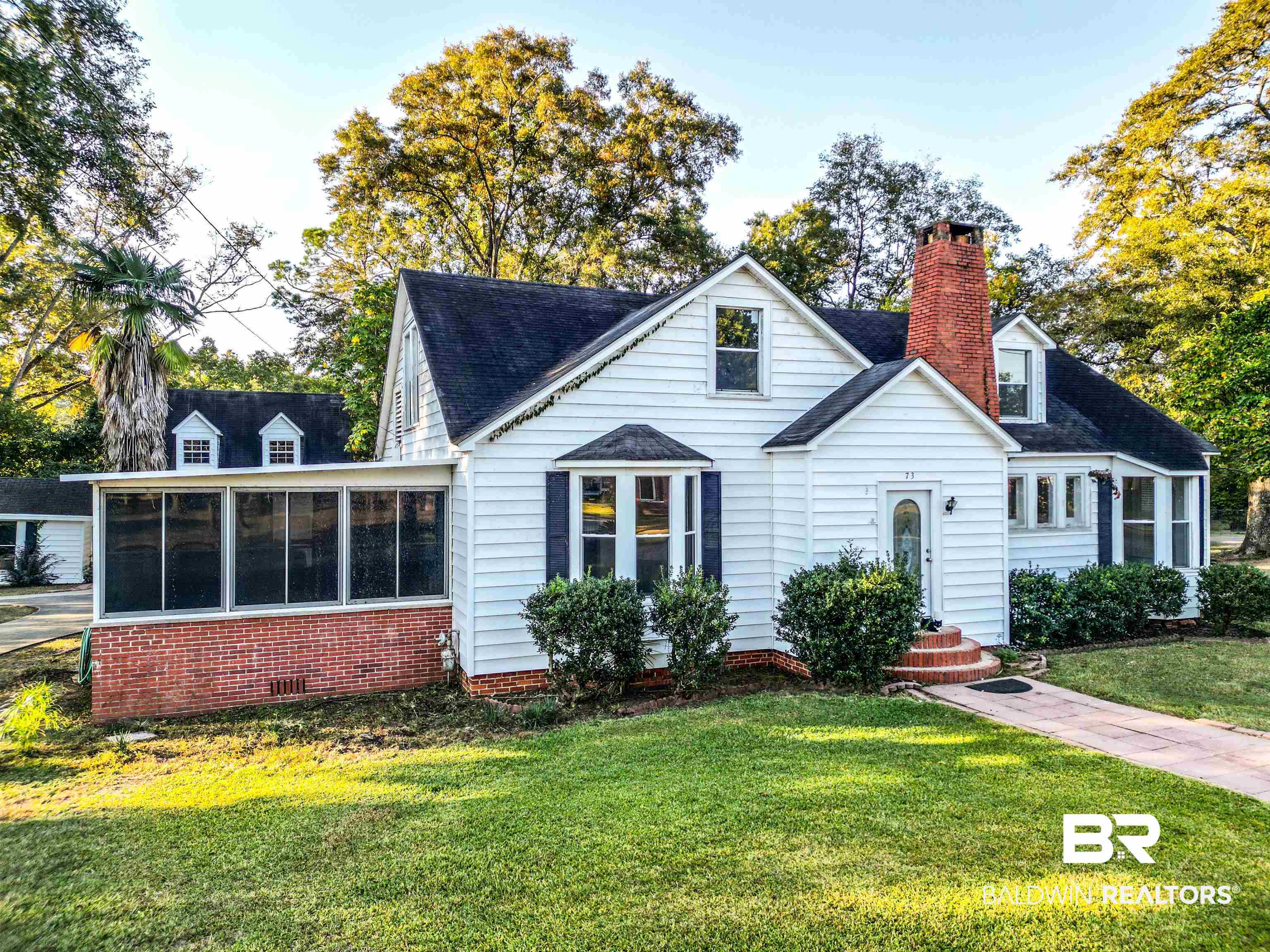 73 Liberty Street Monroeville, AL 36460 - Photo 1 of 29 Cape cod home with a front yard and a sunroom