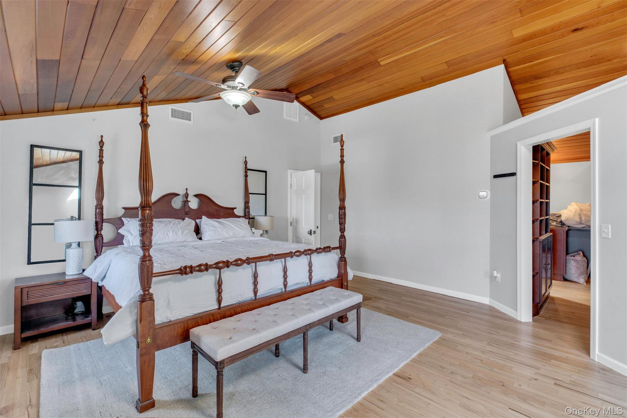 345 Colonial Road Southold, NY 11971 - Photo 20 of 43 a bedroom with furniture and wooden floor