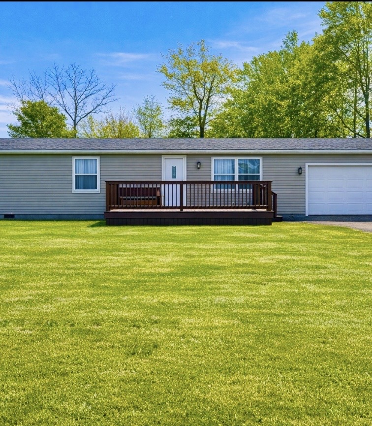 5840 Pitchin Road South Springfield, OH 45502 - Photo 1 of 18 This charming home offers a welcoming facade with a spacious deck and vibrant green lawn.