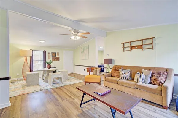 a living room with furniture and wooden floor