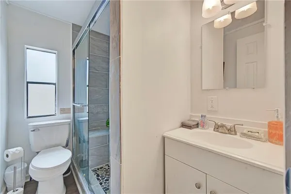a bathroom with a sink toilet and shower