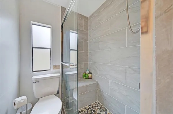 a bathroom with a toilet and a shower